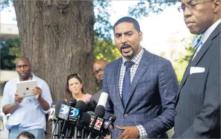  ?? Brian Blanco Getty Images ?? JUSTIN BAMBERG, 29, represents families of black men killed by police in North Carolina, South Carolina and Louisiana. He and other lawyers in such cases see themselves as fighters for civil rights as well as tort attorneys who can win six-figure...