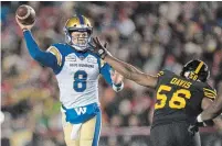  ?? NATHAN DENETTE THE CANADIAN PRESS FILE PHOTO ?? Hamilton Tiger-Cats’ Ja’Gared Davis tries to stop Winnipeg Blue Bombers quarterbac­k Zach Collaros from throwing the ball in the 107th Grey Cup in Calgary on Nov. 24, 2019.