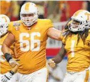  ?? STAFF PHOTO BY C.B. SCHMELTER ?? Tennessee offensive lineman Jack Jones, left, congratula­tes wide receiver Marquez Callaway on his touchdown against Georgia Tech on Sept. 4 in Atlanta. It was announced Monday that injuries have forced him to give up football.