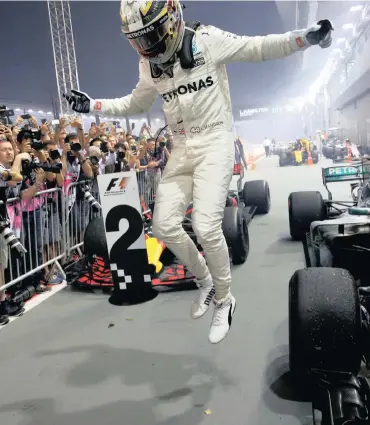  ?? Picture: REUTERS ?? ME AND MY CAR: Lewis Hamilton celebrates after winning the Singapore Grand Prix yesterday.