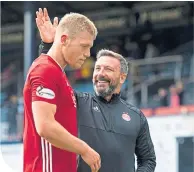  ??  ?? McInnes congratula­tes goal ace Sam Cosgrove