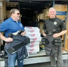  ?? SUBMITTED PHOTO ?? West Chester Police Jim Moorehead (right) assists in the vest collection program