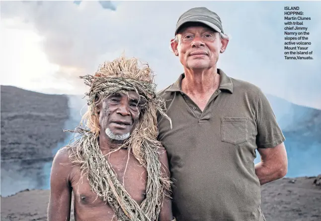  ?? ?? ISLAND HOPPING: Martin Clunes with tribal chief Jimmy Namry on the slopes of the active volcano Mount Yasur on the island of Tanna,Vanuatu.