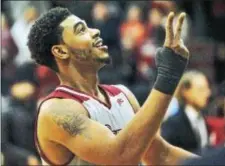  ?? KYLE FRANKO — TRENTONIAN PHOTO ?? Rider’s Dimencio Vaughn gestures to cut down the net after the Broncs defeated Iona, 110-101, on Sunday afternoon to clinch the MAAC regular season title.