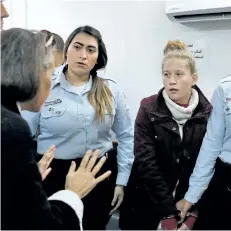  ?? AHMAD GHARABLI/GETTY IMAGES ?? Ahed Tamimi, right, appears at a military court at the Israeli-run Ofer prison in the West Bank village of Betunia on Dec. 25. Israel’s army arrested Tamimi after a video went viral of her slapping Israeli soldiers in the occupied West Bank as they...