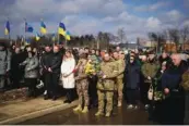  ?? AP PHOTO/THIBAULT CAMUS ?? Mourners gather for the Tuesday funeral of 29-year-old Yana Rikhlitska, a Ukrainian army medic killed in the Bakhmut area, in Vinnytsia, Ukraine.