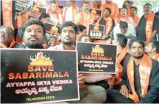  ?? — AFP ?? Members of the Sabarimala Ayyappa Seva Samajam stage a protest in Hyderabad on Tuesday, following the arrest of devotees at Sabarimala temple in Kerala.