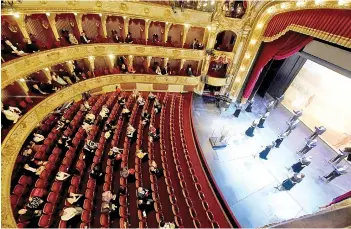  ?? Photo — AFP ?? Spectators maintain social distancing rules as they a end an opera at the Croatian National Theatre in Zagreb a er a two-month closure aimed at stemming the spread of the Covid-19 pandemic, caused by the novel coronaviru­s.