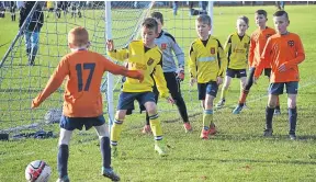  ??  ?? Ferry (yellow) met Fairmuir in an Age 9 fixture at Dawson Park.