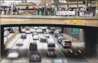  ?? Reed Saxon Associated Press ?? PROTESTERS from Refuse Fascism, shown here on an overpass, have twice stopped all traffic on the 101 Freeway.