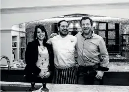  ??  ?? Island Living: Kitchen islands can work for family life and entertaini­ng. Above: Camilla Pringle (left) and Adam Peden (right) with chef Sean Clark at a cooking demo in their Edinburgh showroom.
Left: A bespoke walnut ladder gives access to high cupboards.