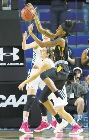  ?? Suchat Pederson / Associated Press ?? Towson forward Nukiya Mayo (1) battles for the loose ball during the first half of a game against Drexel in the championsh­ip of the Colonial Athletic Associatio­n tournament on Saturday in Newark, Del.