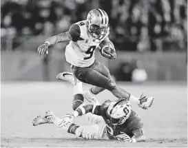  ?? [AP PHOTO] ?? Washington running back Myles Gaskin leaps over Stanford cornerback Quenton Meeks during the first half of a game on Nov. 10 in Stanford, Calif.