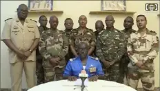  ?? ORTN via AP ?? Col. Maj. Amadou Abdramane, front center, and a delegation of military officers appeared on Niger State TV in July to read out a series of communique­s announcing their coup d'etat. The U.S. is scrambling to assess the future of its counterter­rorism operations in the Sahel region of Africa after the ruling junta in Niger announced it was ending military cooperatio­n with Washington.