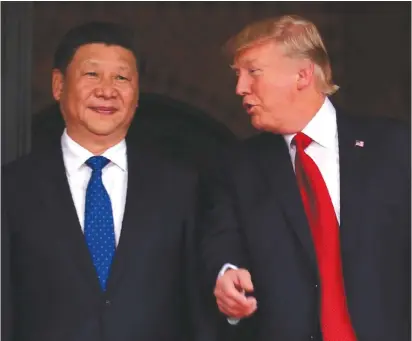  ?? ( Carlos Barria/ Reuters) ?? US PRESIDENT Donald Trump talks to Chinese President Xi Jinping at Trump’s Mar- a- Lago estate in West Palm Beach, Florida, in 2017.