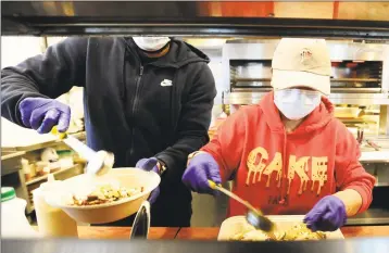  ?? Matthew Brown / Hearst Connecticu­t Media ?? Mexicue staff prepare a takeout order on April 29 in Stamford.