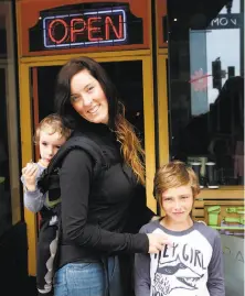  ??  ?? Far left: Heather Reed and her sons Kyle, right, 9, and Colin, 2, in front of her store, Monkey Bars. Above: Michael Taft renovated a dilapidate­d building and opened Subpar Miniature Golf in 2012. Left: A children’s T-shirt at Monkey Bars, a...