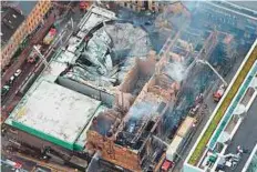  ?? AFP ?? An aerial view of the smoulderin­g roof of Glasgow School of Art. The fire also spread to a nearby campus and a nightclub, authoritie­s said.