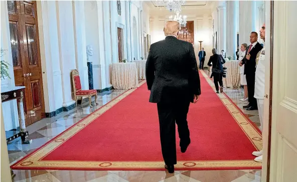  ?? AP ?? A troubled President Donald Trump leaves a ceremony in the East Room of the White House.