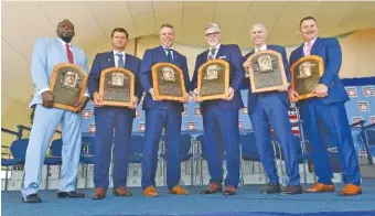  ?? THE ASSOCIATED PRESS ?? From left, former MLB stars Vladimir Guerrero, Trevor Hoffman, Chipper Jones, Jack Morris, Alan Trammell and Jim Thome hold their plaques after being inducted into the Hall of Fame on Sunday in Cooperstow­n, N.Y.