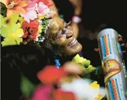  ?? BUDA MENDES/GETTY ?? A reveler attends the annual block party known as Ceu na Terra, or Heaven on Earth, on the second day of Carnival on Saturday in Rio de Janeiro.