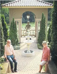  ?? JEFF WHEELER TRIBUNE NEWS SERVICE ?? Brian Ellingson, left, with his husband, Gary Domann, and the pavilion they had built from leftover home reno materials.