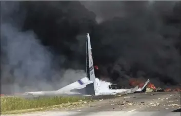  ??  ?? Flames and smoke rise from an Air National Guard C-130 cargo plane after crashed near Savannah, Ga., on Wednesday. JAMES LAVINE VIA AP