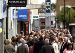  ?? Max Nash/Associated Press ?? Customers stand in a queue outside a branch of the Northern Rock, the British mortgage lender, in Harrow, London, on Sept. 17, 2007. Shares of Northern Rock were hit by a liquidity crisis, which sent customers lining up to withdraw their deposits.