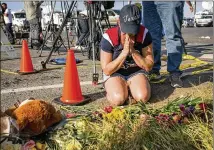  ?? JAY JANNER / AMERICAN-STATESMAN ?? Rebecca Thompson of Santa Fe, Texas, prays Monday at a memorial near the First Baptist Church in Sutherland Springs, where 26 churchgoer­s now need funerals.