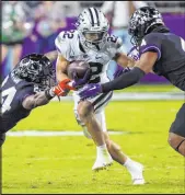  ?? The Associated Press ?? Richard W. Rodriguez
TCU cornerback Josh Newton, left, and safety Namdi Obiazor try to stop Kansas State running back Deuce Vaughn in the second half of the Horned Frogs’ victory Saturday at Amon G. Carter Stadium.