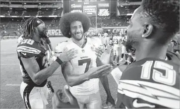  ?? K.C. Alfred San Diego Union-Tribune ?? COLIN KAEPERNICK, center, who led the San Francisco 49ers to Super Bowl XLVII, was criticized by some after taking a knee during the playing of the national anthem last season.