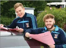  ??  ?? All smiles by St Michael’s students Roger Lawon and Niall O’Sullivan last week, before Niall (below) hit the road ready for another round with the Leaving Cert.