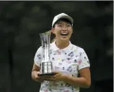  ?? TIM IRELAND — THE ASSOCIATED PRESS ?? Japan’s Hinako Shibuno reacts as she holds the trophy as she celebrates after winning the Women’s British Open golf championsh­ip at Woburn Gold Club near near Milton Keynes, England, Sunday.