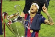  ?? MICHAEL SOHN — THE ASSOCIATED PRESS ?? In this Saturday, June 6, 2015 file photo, Barcelona’s Neymar celebrates with the trophy after the Champions League final soccer match between Juventus Turin and FC Barcelona at the Olympic stadium in Berlin.