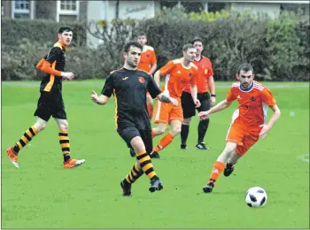  ??  ?? Concentrat­ion etched on his face Archie McNicol wins the race for the ball.