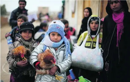  ?? Muhammad Hamed / Reuters ?? Families forced into refugee camps are being taken home after the recapture of the east of Mosul.