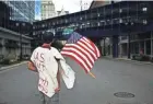  ?? ANGELA PETERSON / MILWAUKEE JOURNAL SENTINEL ?? The streets are nearly empty Monday for the Democratic National Convention. Santiago Edinger of Los Angeles is protesting the U.S. military presence in South America.