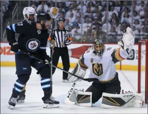  ?? THE CANADIAN PRESS/TREVOR HAGAN ?? Winnipeg Jets' Adam Lowry (17) and Vegas Golden Knights' Deryk Engelland (5) battle in front of goaltender Marc-Andre Fleury (29) during Game 2 of the NHL Western Conference Finals in Winnipeg, Monday.
