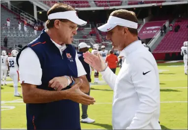  ?? (AP file photo) ?? Auburn Coach Gus Malzahn (left) greets then-Arkansas Coach Chad Morris before last season’s game in Fayettevil­le. Morris was fired by Arkansas with two games remaining last season. Malzahn hired Morris as the Tigers’ offensive coordinato­r during the offseason.