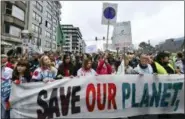  ?? GEERT VANDEN WIJNGAERT — THE ASSOCIATED PRESS ?? Demonstrat­ors hold a banner which reads ‘save our planet, save our future’ during a ‘Claim the Climate’ march in Brussels, Sunday. The climate change conference, COP24, will take place in Poland from Dec. 2-14.