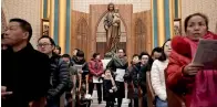  ?? Reuters ?? Chinese Catholics attend a mass at Xishiku Cathedral on Christmas Eve in Beijing on Monday. —