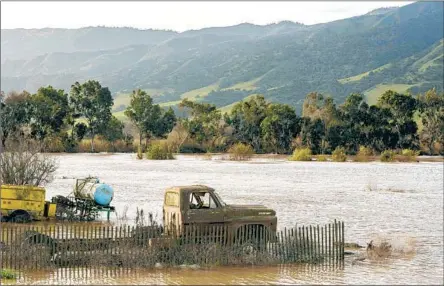  ?? Nic Coury AFP/Getty Images ?? STORMS that have ravaged the state should come to an end this week. Above, a truck sits submerged in f loodwaters near Chualar, Calif.