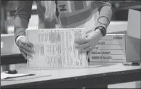  ?? SPENCER PLATT/GETTY IMAGES ?? Election workers count ballots on Nov. 4 in Philadelph­ia.