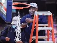  ?? Frank Franklin II / Associated Press ?? Georgetown head coach Patrick Ewing cuts down the net after winning the Big East title on March 13.