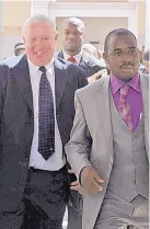  ?? TSVANGIRAY­I MUKWAZHI/THE ASSOCIATED PRESS ?? Roy Bennett, left, leaves the High Court in Harare, Zimbabwe, after he was acquitted of terrorism charges in 2010. Bennett was a key leader of the opposition to Robert Mugabe.