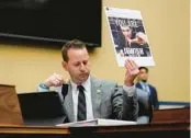  ?? CAROLYN KASTER/AP ?? U.S. Rep. Jared Moskowitz, D-Parkland, holds up a comment sent to his Twitter account during a House Committee on Oversight and Accountabi­lity hearing on Capitol Hill on Wednesday.