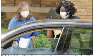  ?? (Arkansas Democrat-Gazette/John Sykes Jr.) ?? Kim Burleson (left) and Cheree Buchanan help out Monday morning at Little Rock Central High School as the city’s school district attempts to get computers and tablets to students who are now doing their schoolwork from home.