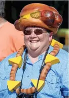  ?? GARY C. KLEIN/USA TODAY NETWORK-WISCONSIN ?? Betty Schmitt of Sheboygan is all decked out in Brat gear during the Brat Day Parade in August 2017 in Sheboygan.