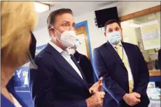  ?? Ned Gerard / Hearst Connecticu­t Media ?? Gov. Ned Lamont speaks with state and Bridgeport education officials, including Superinten­dent of Schools Mike Testani, right, during a tour of Blackham School in Bridgeport on Monday.