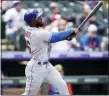  ?? AP PHOTO/DAVID ZALUBOWSKI ?? New York Mets’ Starling Marte follows the flight of his two-run home run off Colorado Rockies starting pitcher German Marquez in the first inning during the first baseball game of a doublehead­er, Saturday, May 21 2022, in Denver.